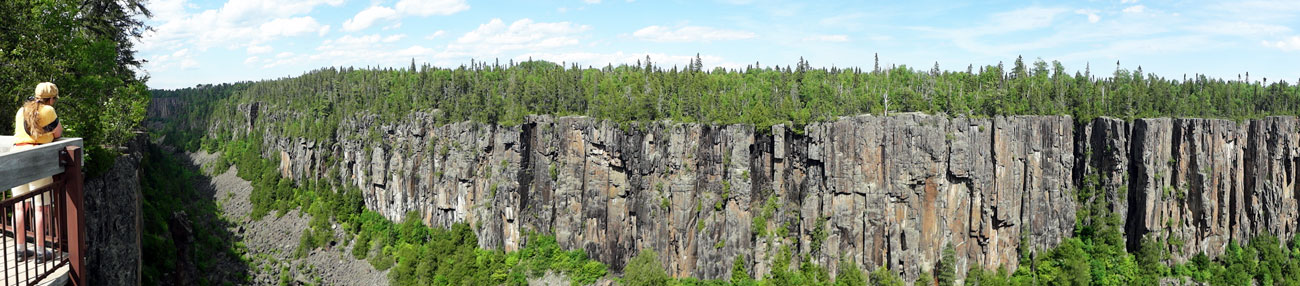 Karen Duquette and a panorama of Ouimet Canyon in Canada